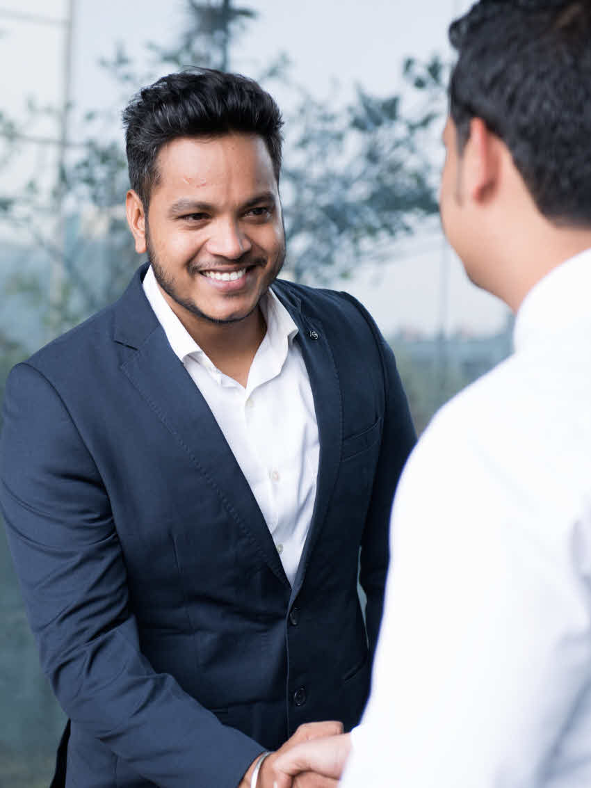 Male DSV employee shaking hands another with a customer